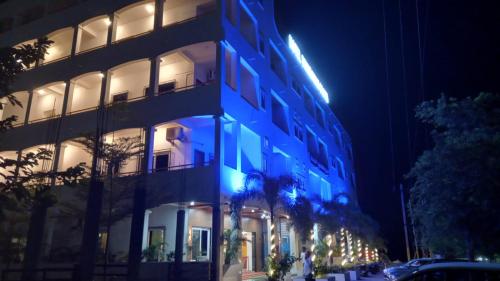 a building with blue lights on the side of it at Hotel Brindavan Grand in Gulbarga