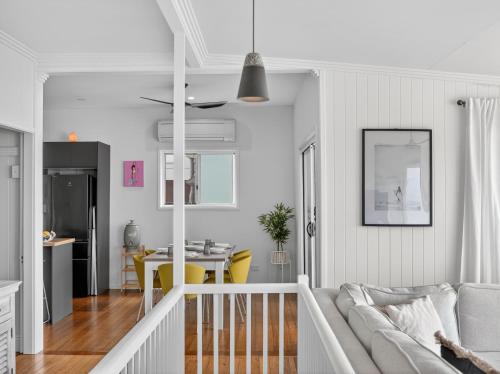 a living room with a couch and a dining room at The Pink Door, Absolute Beachfront House in Scarborough