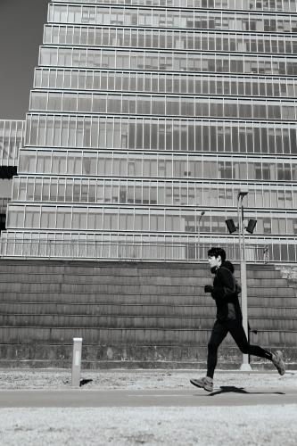 a man running down a street in front of a building at Hotel Onoma Daejeon, Autograph Collection in Daejeon