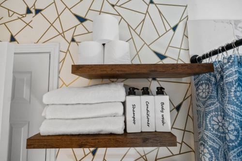 a bathroom with towels and toilet paper on a shelf at Relaxation spot lawrenceville in Lawrenceville