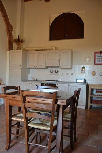 a kitchen with a table and chairs and a stove at Antico Borgo Casalappi in Campiglia Marittima