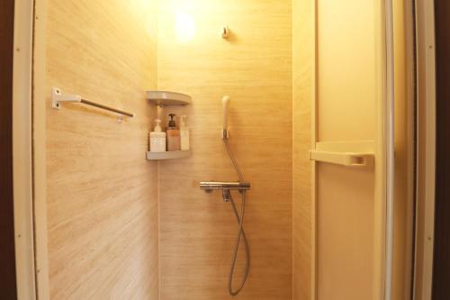 a bathroom with a shower with a shower head at Glamping Village LEAF in Mashiki