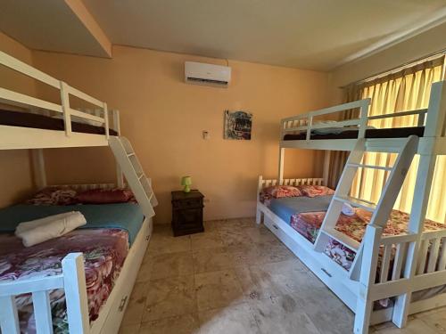 a room with two bunk beds in a house at Casa Puerto in El Garitón