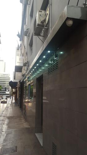 a building with a sidewalk next to a street at Hotel El Porteño in Buenos Aires
