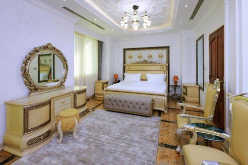 a bedroom with a bed and a mirror at Fountain Palace Hotel & Suites in Kampala