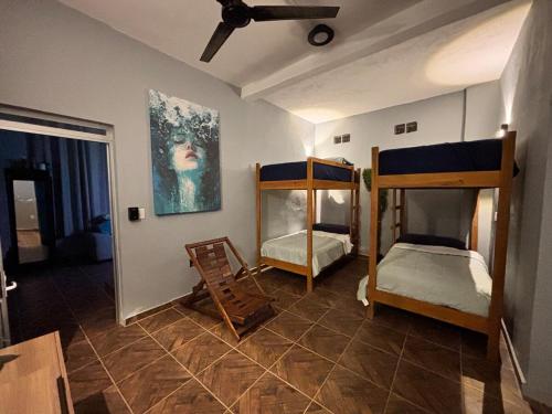 a room with two bunk beds and a ceiling at Private Pool Villa Near Bacalar Lagoon in Xul-Ha