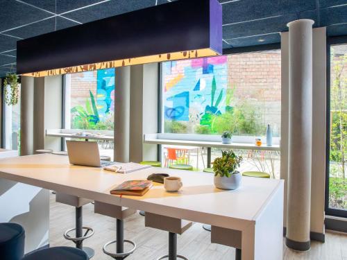 an office with a desk with a laptop on it at Ibis Budget Strasbourg Centre Republique in Strasbourg