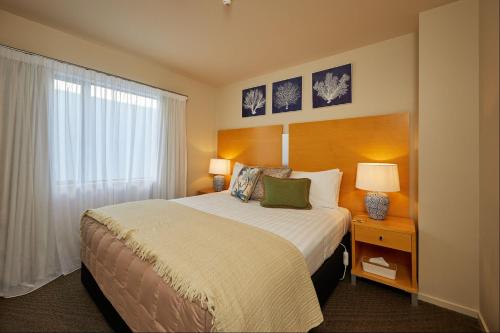 a hotel room with a bed and a window at Kaikoura Luxury Apartments - Formerly Waves Luxury Apartments in Kaikoura