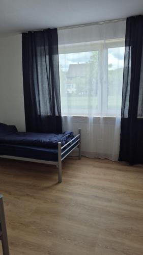 a bedroom with a bed and a window at Monteurhome Monteurzimmer A7 A5 in Niederaula