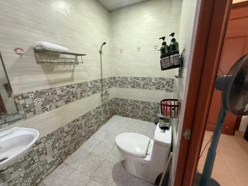a bathroom with a toilet and a sink at Cactos Pool & Palms Local Stay in Ho Chi Minh City