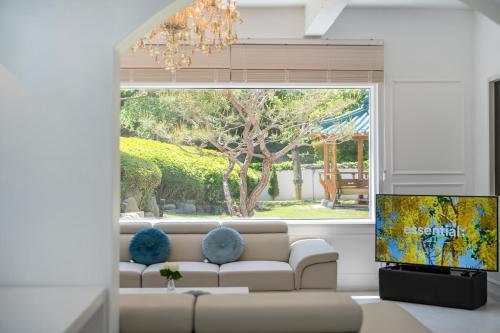 a living room with a couch and a large window at 초음정 Luxury Hanok Style Villa with Private Garden in Gyeongju in Gyeongju
