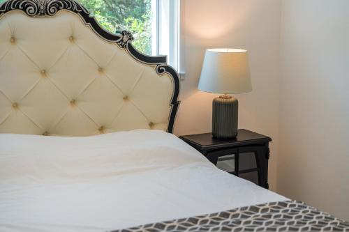 a bedroom with a bed and a lamp on a table at 초음정 Luxury Hanok Style Villa with Private Garden in Gyeongju in Gyeongju