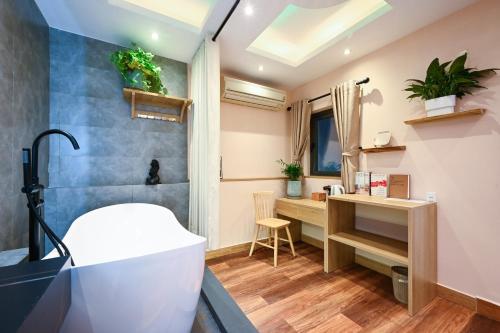 a bathroom with a sink and a desk at Harmony Stay - Ben Thanh Market in Ho Chi Minh City