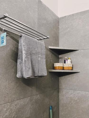 a bathroom with a towel hanging on a wall at Parijat Heritage in Bhubaneshwar