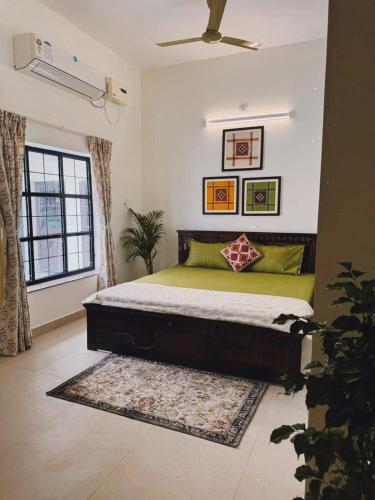a bedroom with a large bed in a room at Parijat Heritage in Bhubaneshwar