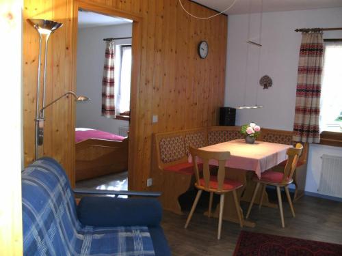 a room with a table and chairs and a bedroom at Haus Aretz in Feldberg
