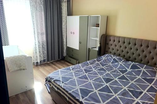 a bedroom with a bed with a blue comforter at Caesar resort 2 bedrooms Cornelius in Vrysoules