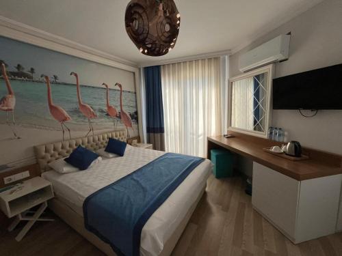 a bedroom with a bed with pink flamingos on the wall at River suite hotel in Manavgat