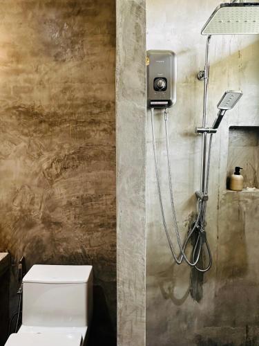 a bathroom with a shower with a toilet in it at Glai boutique hotel in Ban Cha Prong