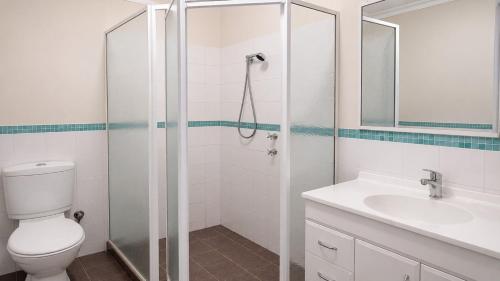 a bathroom with a shower and a toilet and a sink at Beachside on Kent in Busselton