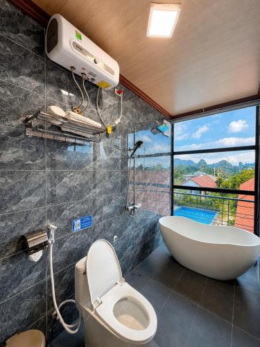 a bathroom with a tub and a toilet and a sink at Trang An Green Retreat Homestay in Ninh Binh