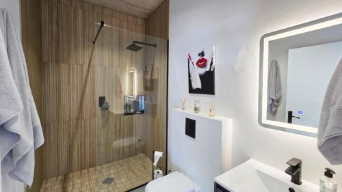 a bathroom with a shower and a toilet and a sink at Walvishaai in Stompneusbaai