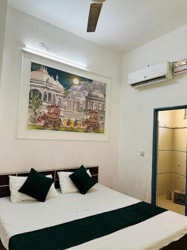a bedroom with a bed with a painting on the wall at Hotel park view in Bathinda