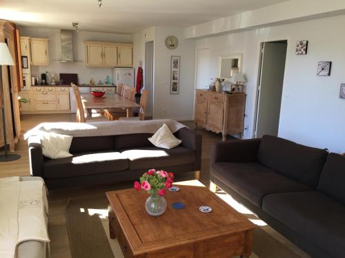 a living room with a couch and a table at La Maison D'ILHAN in Ilhan