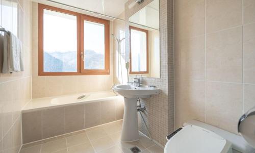 a bathroom with a sink and a toilet and a tub at Elysian Gangchon Resort in Chuncheon