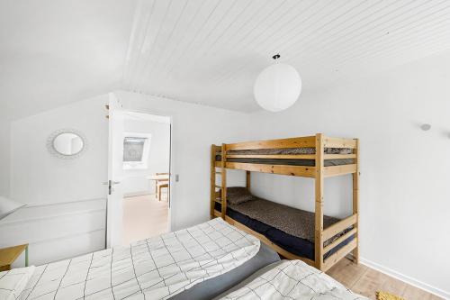 a bedroom with a bunk bed and a ladder at Holiday Apartment On Bornholm With Sea View in Svaneke