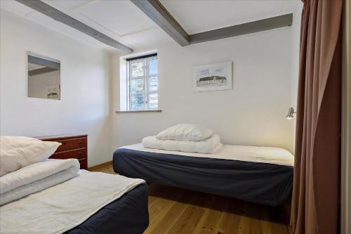a bedroom with two beds and a window at Holiday Apartment In Peaceful Surroundings in Neksø