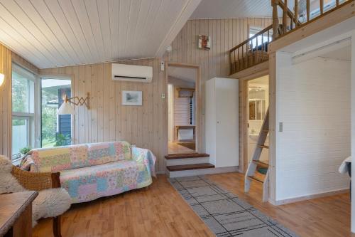 a living room with a couch and a staircase at Close To The Beach And Forest And Ebeltoft in Ebeltoft