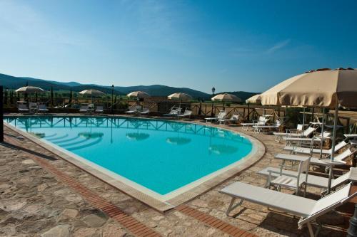 a swimming pool with a pool table and chairs at Antico Borgo Casalappi in Campiglia Marittima