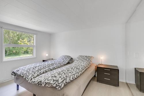 a white bedroom with a bed and a window at Unique Holiday Home In Quiet Surroundings in Storvorde