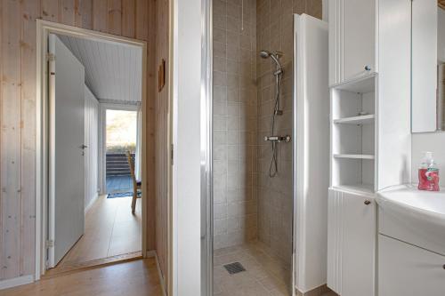 a bathroom with a shower and a sink at Cozy Summer House On Scenic Djursland in Glesborg