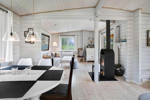 a living room with a table and a dining room at The Sun House in Hundested