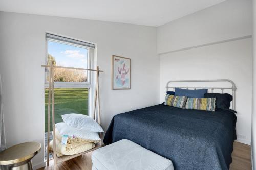 a bedroom with a bed and a window at Unique New Beach-House I Seaview And Space in Vejby