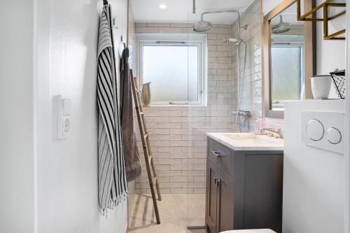 a bathroom with a sink and a window at Unique New Beach-House I Seaview And Space in Vejby
