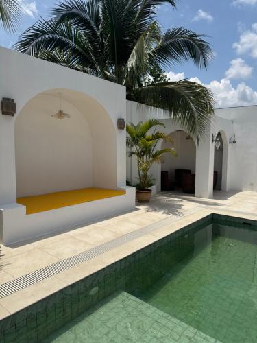 a pool in a villa with a palm tree at Bayu senja in Lahad Datu