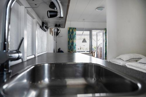 a kitchen with a stainless steel sink in a room at Cozy Holiday Apartment Close To The Beach in Neksø