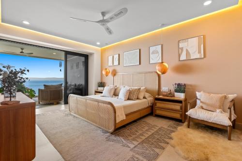 a bedroom with a bed and a view of the ocean at PANAREA - Luxury Beachfront Condos in Bucerias in Bucerías