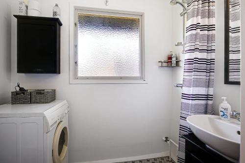 a bathroom with a washing machine and a window at Charming Holiday Home At Sought-After Tisvilde in Vejby