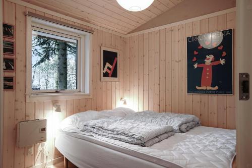 a bedroom with a bed in a room with a window at Nice Summer House In The Middle Of The Forest in Store Fuglede