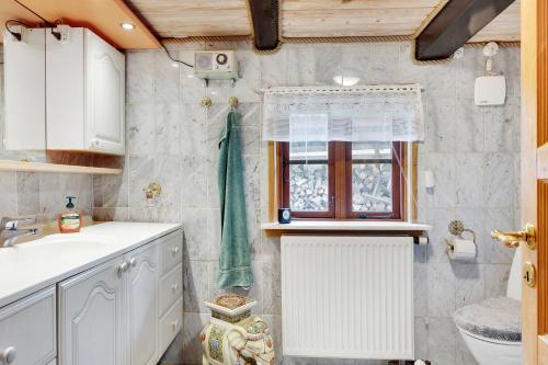 a bathroom with a sink and a window at New Renovated Farmhouse in Slagelse