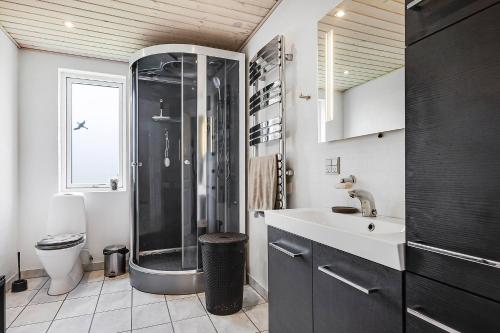 a bathroom with a shower and a sink and a toilet at Cozy And Spacious Townhouse In Aars in Års