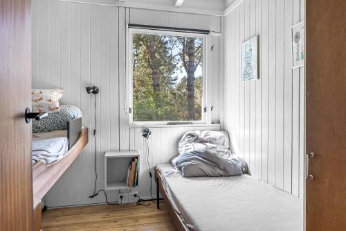 a small room with a bed and a window at Family-Friendly Cottage Close To The Water in Nykøbing Sjælland