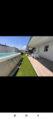 a view of a building with a yard with grass at chalecito con piscina y barbacoa in Benicarló