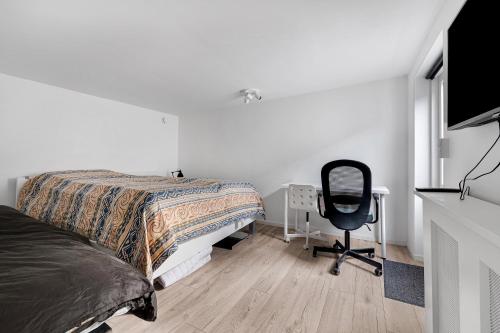 a bedroom with a bed and a desk and a chair at Amazing Holiday Home With View At The Water in Vig