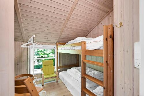 a bedroom with bunk beds in a wooden house at Summer House In Beautiful Nature In Brunshuse in Hårby
