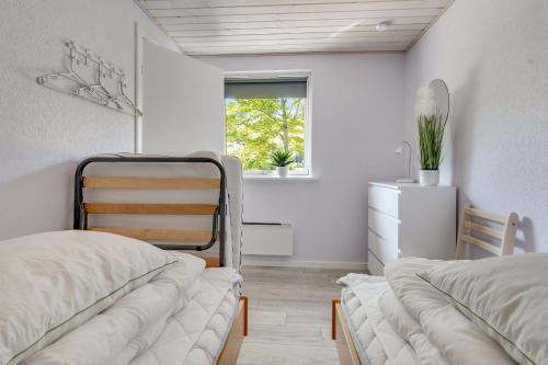 a bedroom with two beds and a window at Holiday Home With Outdoor Jacuzzi And Shelter in Vig